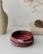 Studio82 large burgundy and brown marble on white material decorative bowl styled on white console on the light backgorund enct to a stone vase